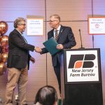 Distinguished Professor Jim Simon is congratulated by NJ Farm Bureau President Allen Carter. Courtesy of NJFB.