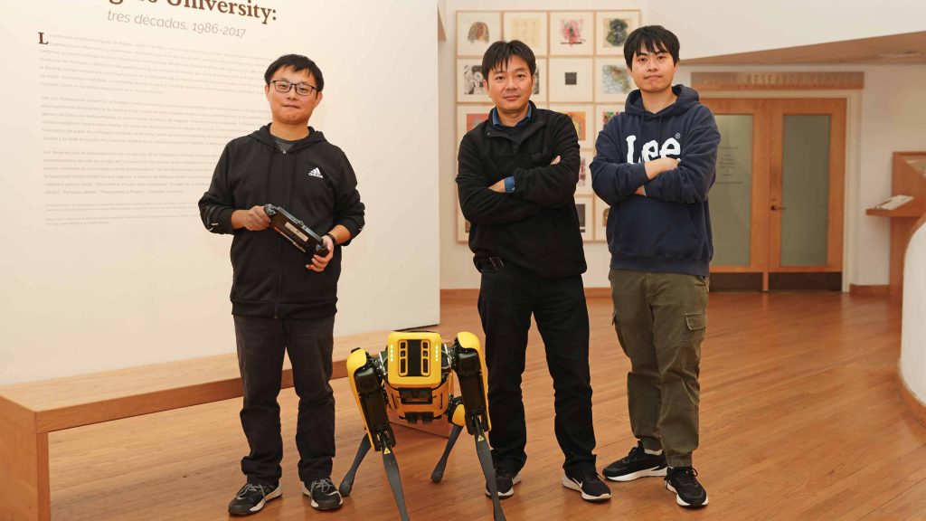 Fifth-year engineering student Chong Di (left), Professor Jie Gong and Shengyuan Feng, a graduate student studying artificial intelligence, pose with Echo the robot in the Zimmerli Art Museum.
Luca Mostello/Rutgers University