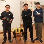 Fifth-year engineering student Chong Di (left), Professor Jie Gong and Shengyuan Feng, a graduate student studying artificial intelligence, pose with Echo the robot in the Zimmerli Art Museum. Luca Mostello/Rutgers University