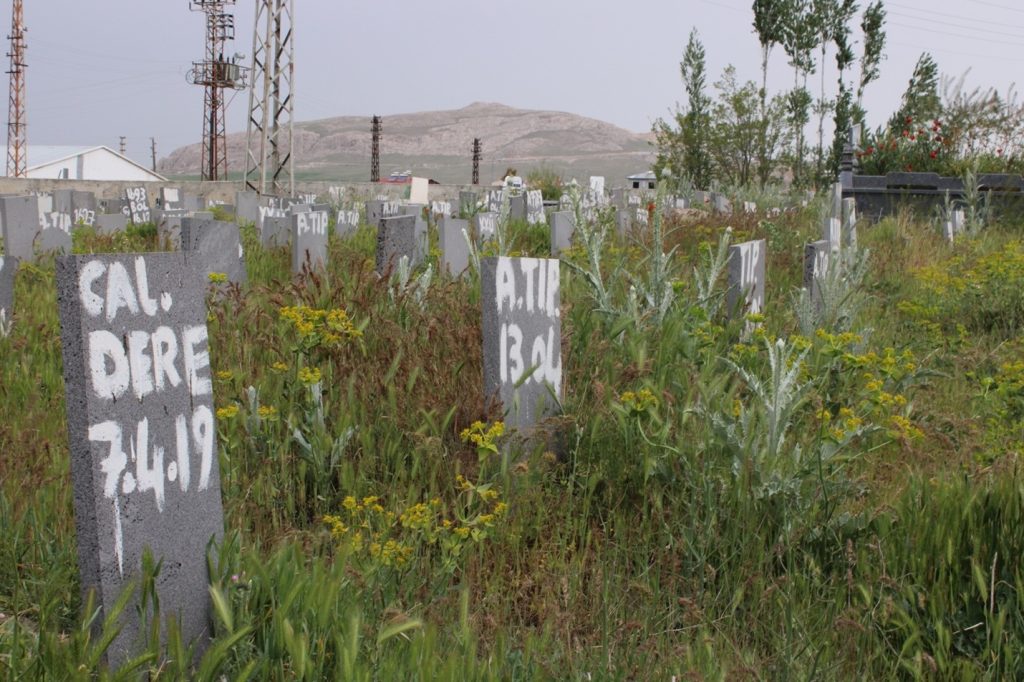 Photo Title: Care After Death - 2023Place where the photo taken: Northern Kurdistan – Eastern Turkey
Explanation of the photo: The Cemetery of the Nameless where “irregular migrants,” who died while attempting to cross the Turkish-Iranian border, decorated with a border wall and two ditches, seek peace in the afterlife. The cemetery is the place where personhood ends not because life ends but rather because of the absence of care for the dead and grave.