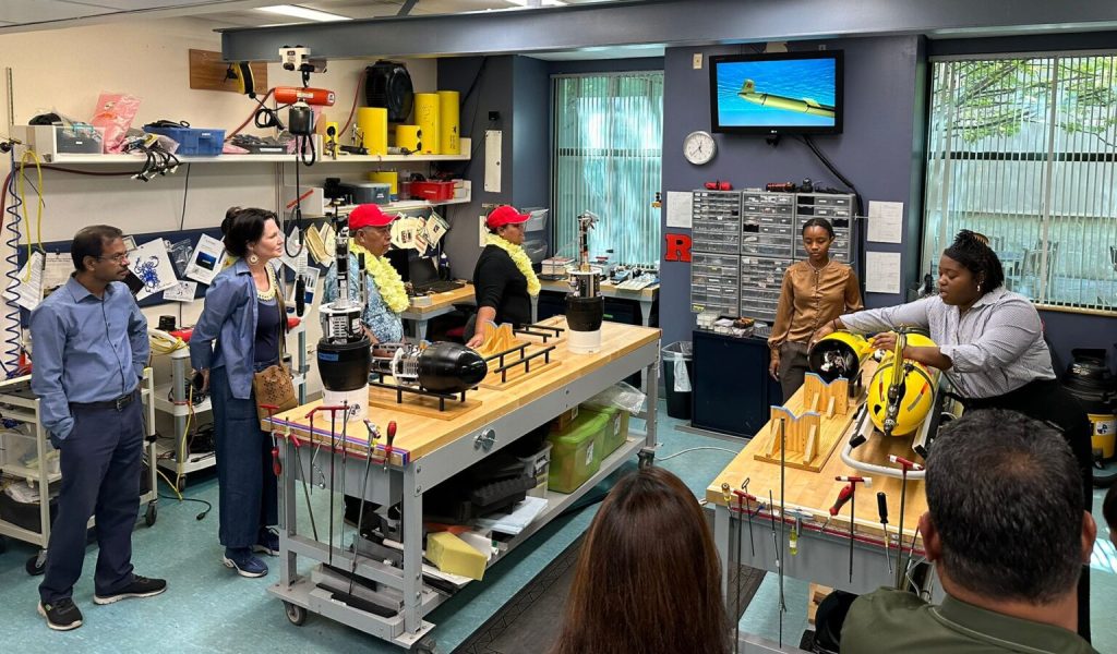 Oceanography graduate students Mya Sharpe and Leah Hopson demonstrate Rutgers glider robots used for ocean monitoring to the visiting dignitaries from the FSM.