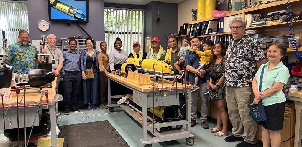 A contingent of Rutgers faculty, staff, students with the visiting dignitaries from the Federated States of Micronesia (wearing leis) at RUCOOL.