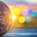 Imagine of the Earth in front of a sparkly background.