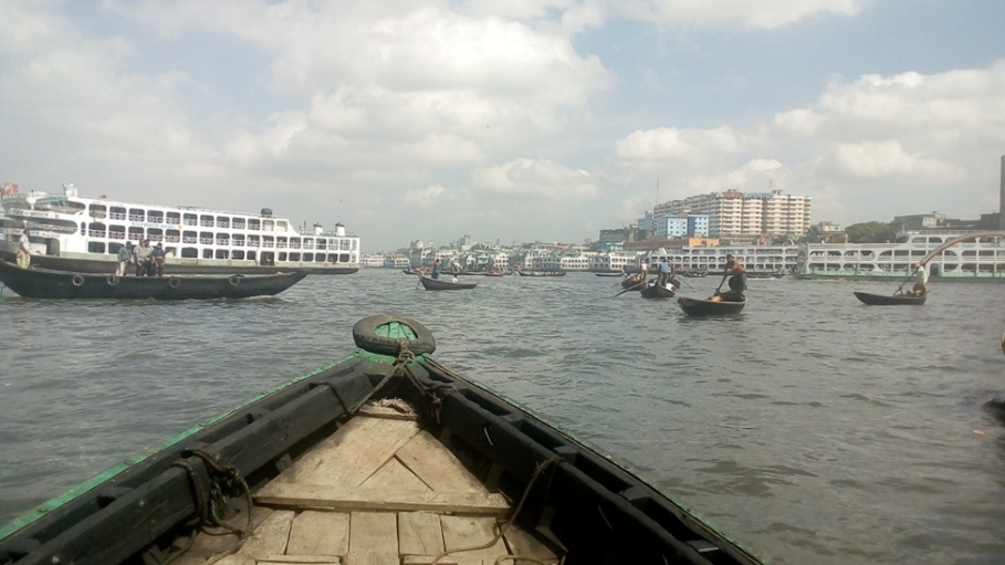 Boats and ferries cross the Buriganga River in Dhaka, Bangladesh.