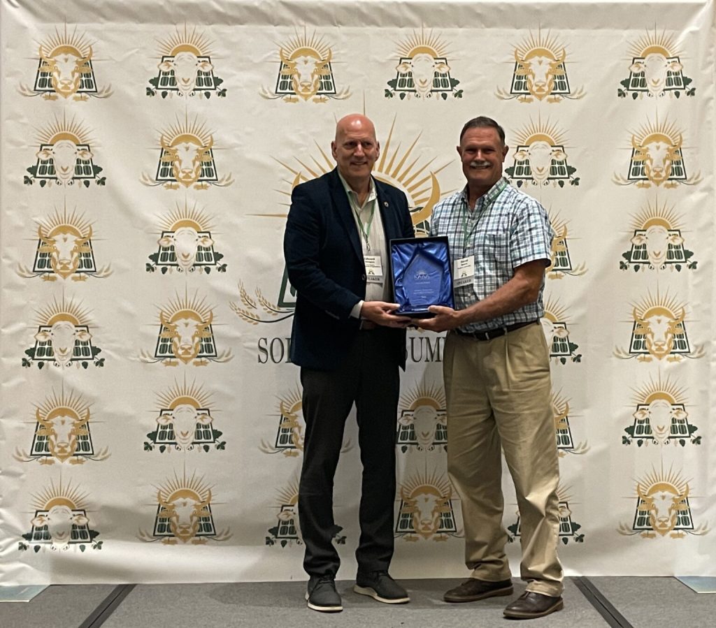 New Jersey Secretary of Agriculture Edward D. Wengryn and Rutgers Agrivoltaics Program Lead Dave Specca standing next to each other, posing with an award.