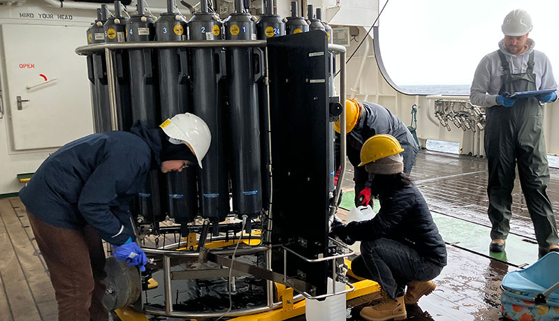 Image of researchers collecting water samples.