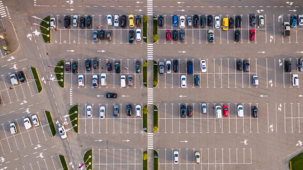 Aerial view of a parking lot littered with cars