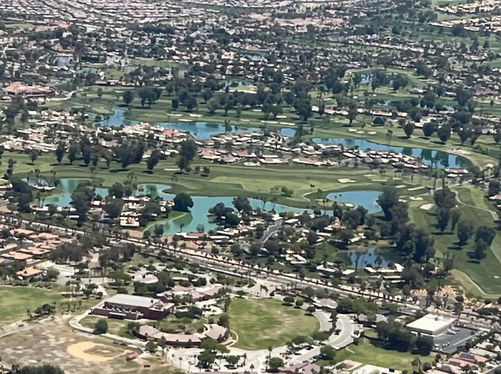 Aerial move of a golf spring above Palm Springs.