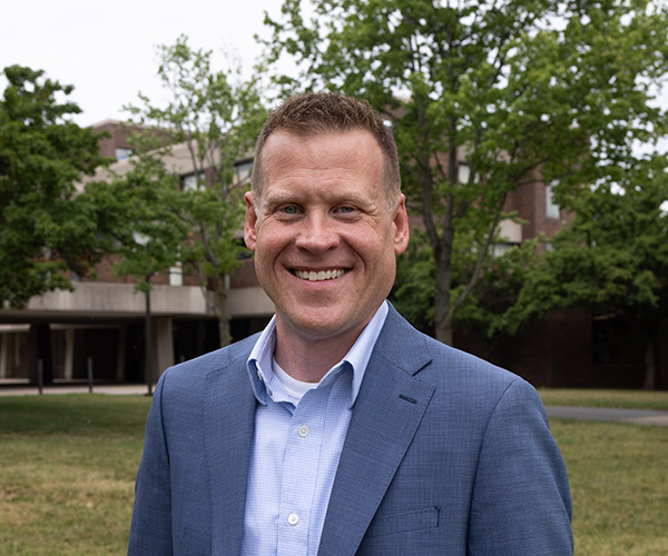 Headshot of John Krasting standing outside